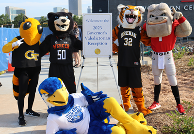 Mascots with 2023 Valedictorian Reception sign